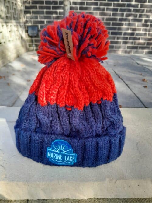 Red and blue knitted bobble hat with an embroidered Clevedon Marine Lake logo on the blue turn-up cuff.